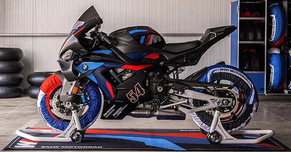2026 BMW M 1000 RR leaned hard through a track corner in a performance riding scene.